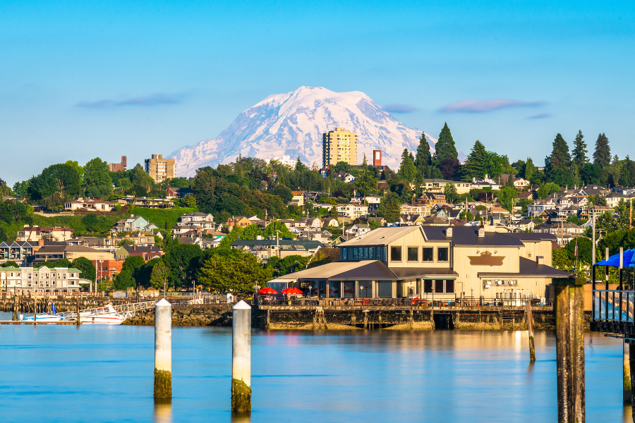 Tacoma-WA.png Tacoma, WA near the water with evergreen trees and mountain in the background