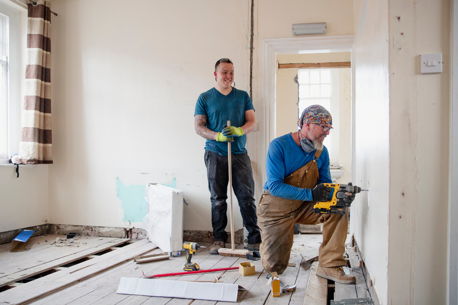 House-Renovation.png Two workers renovating a home