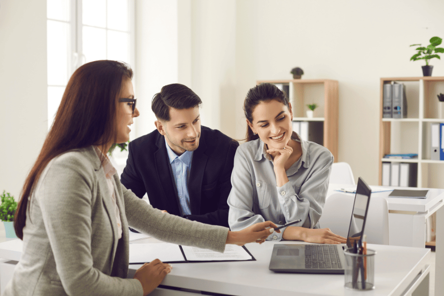 clients meeting with a real estate agent to ask questions and discuss next steps