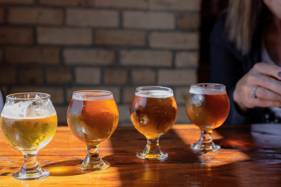 Beer glasses on a wood table at a brewery 