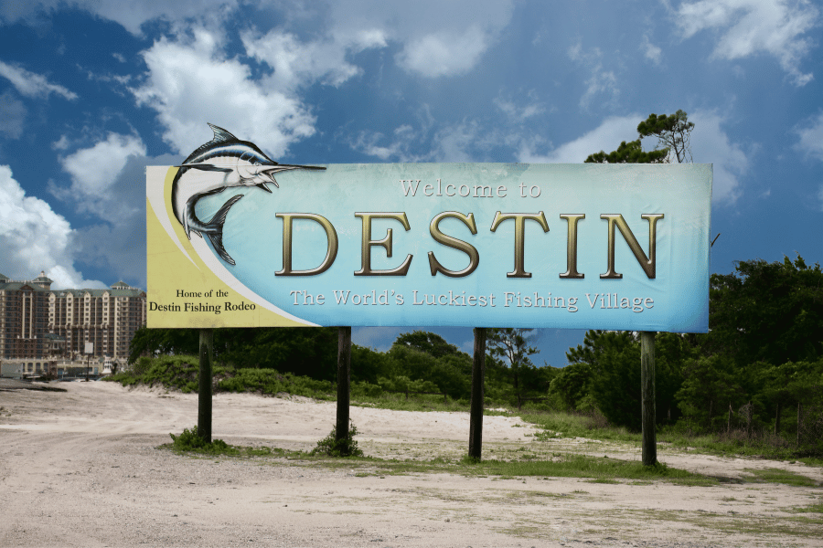 Destin, Florida blue and yellow sign on the beach on a sunny day