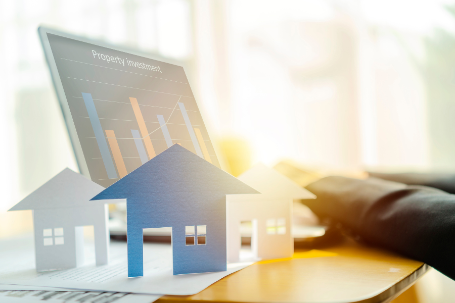 Property-Investment.png Property investment on computer with houses on a table