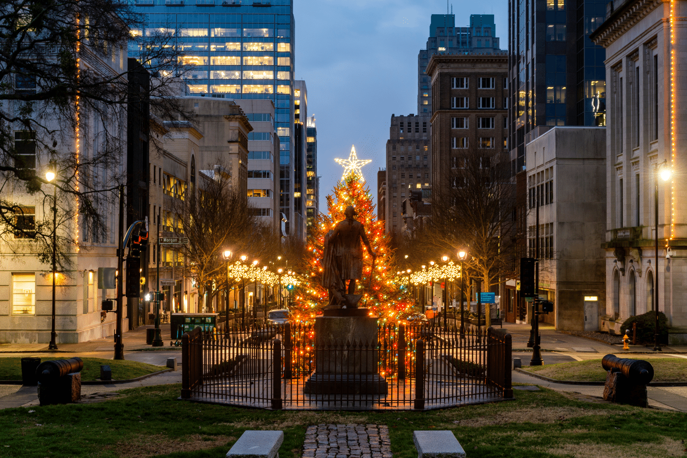 Downtown-Raleigh.png Downtown Raleigh North Carolina Statue in front of capitol building with christmas tree and lights