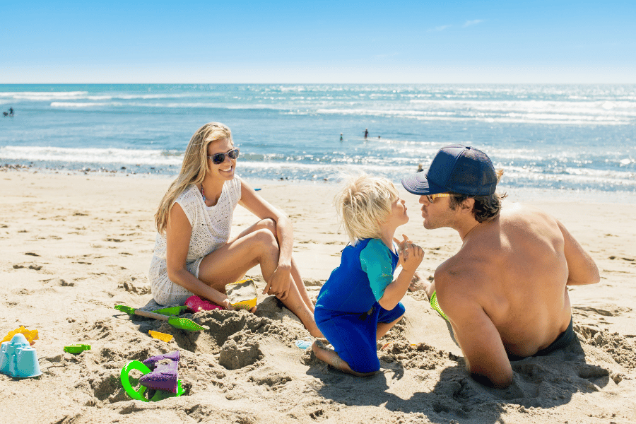 Family at the Beach Family relaxing at the beach on a sunny day
