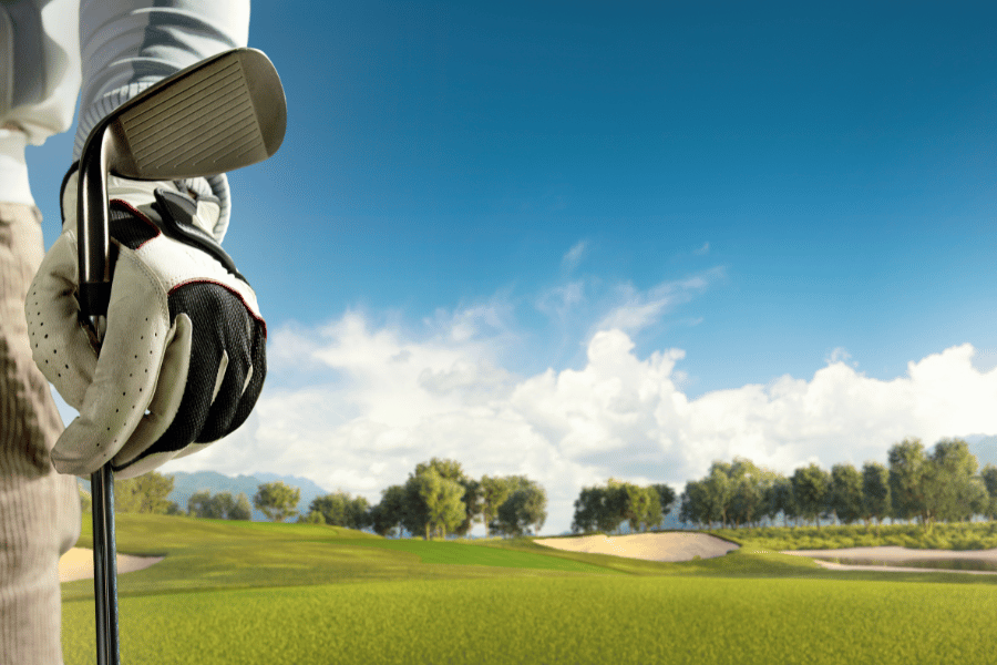 Golfer with club playing golf on a beautiful day 