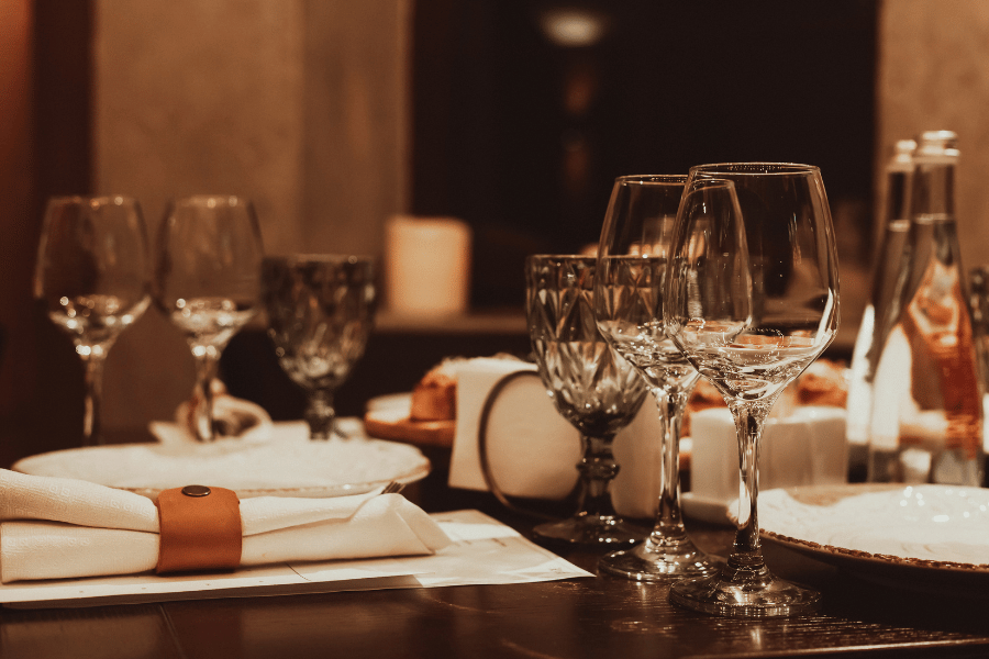 Wine glasses and water glasses on table in restaurant