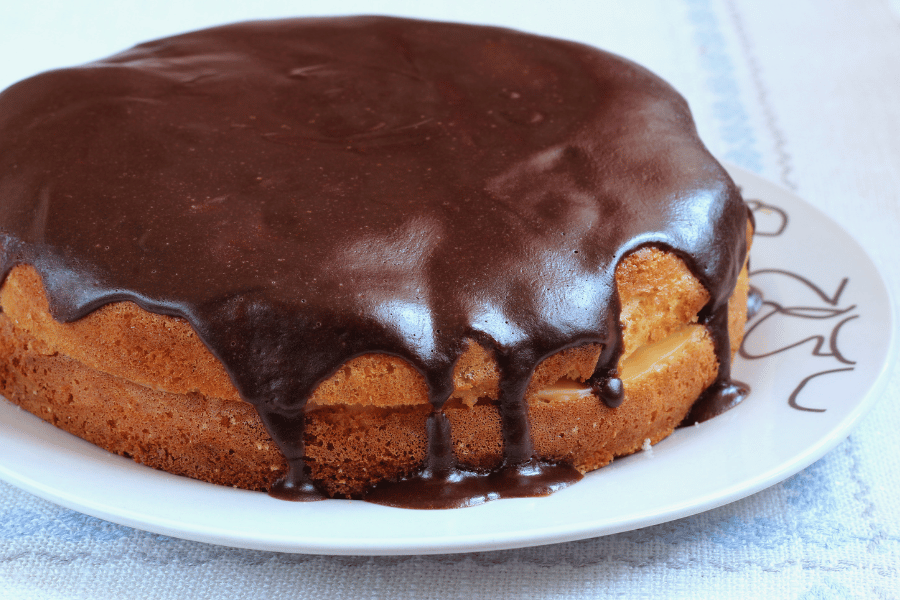 boston cream pie on white plate with chocolate 
