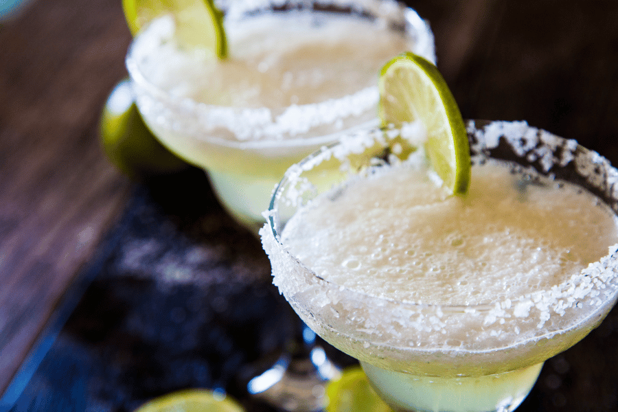 Two margaritas with lime Two margaritas with lime and a salt rim