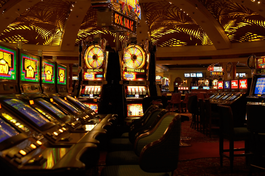 Casino-Reno-NV.png Inside a colorful casino with slot machines at night