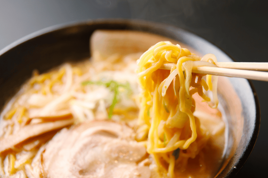Japanese Ramen Eating ramen in a bowl with chop sticks