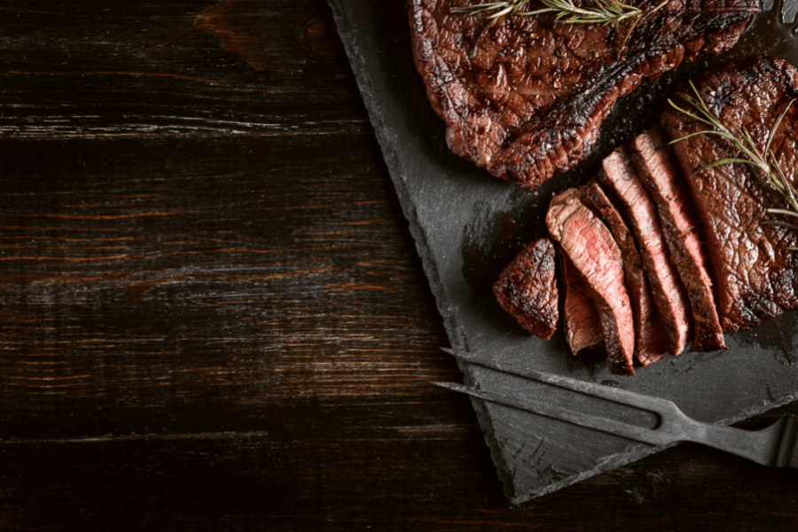Steak cut up steak on a wood background
